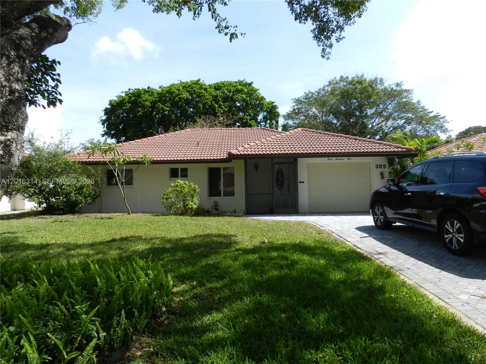 305 Northwest 42nd Street Boca Raton, FL 33431 - Photo 5 of 31 a view of a house with a yard and sitting area