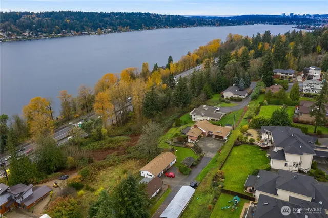 an aerial view of lake residential house with outdoor space and trees around