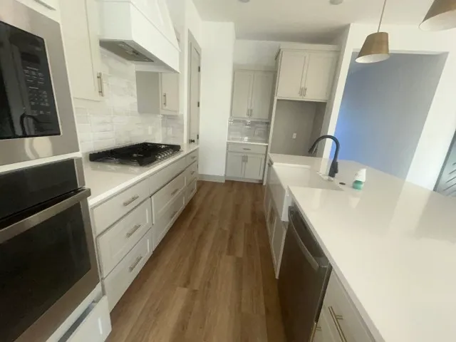 a kitchen with a sink stove and refrigerator