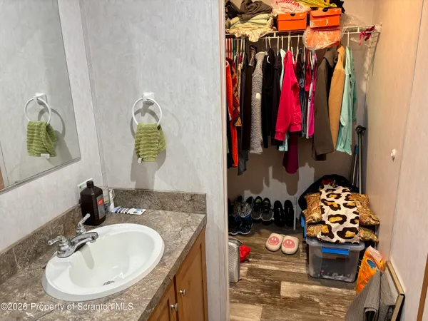 a kitchen with granite countertop a sink a stove and wooden cabinets