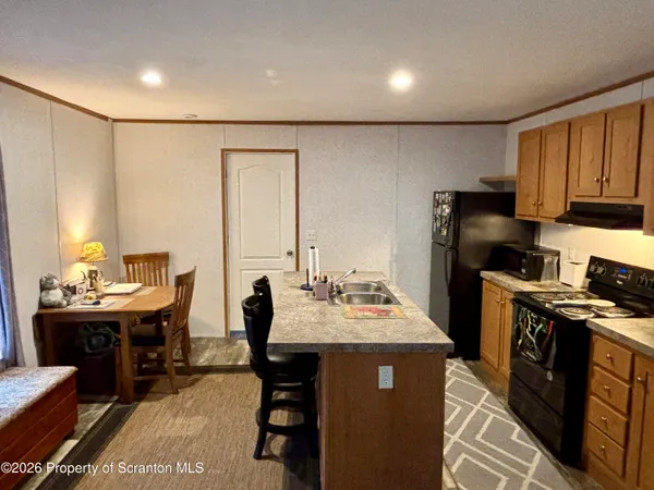 a kitchen with a sink and a refrigerator