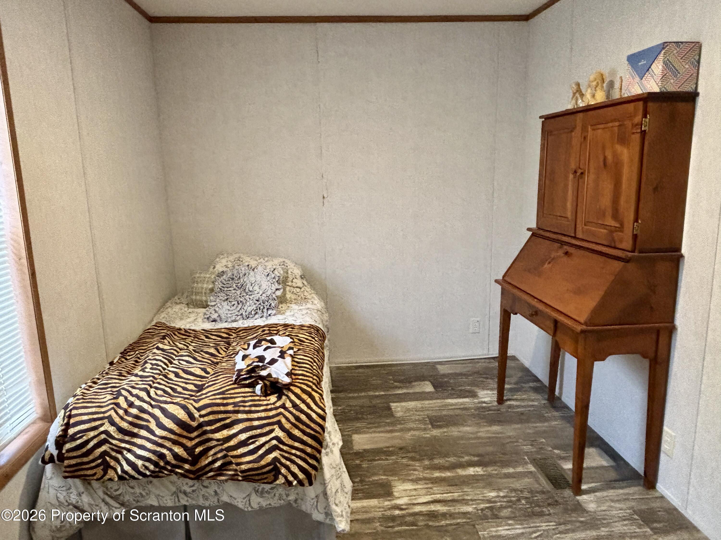 62 Timber Trail Factoryville, PA 18419 - Photo 21 of 23 a bedroom with a bed and wooden floor