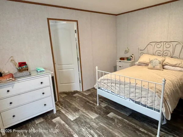 a room with a bed and a mirror