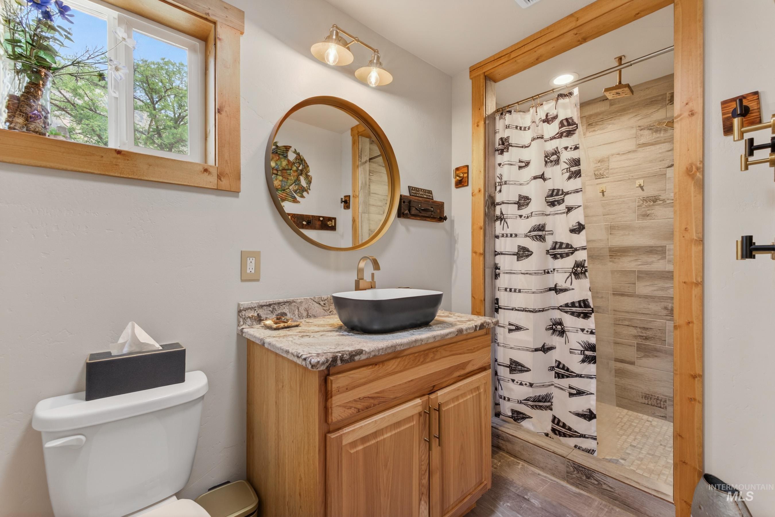 1432 Salmon Drive Riggins, ID 83549 - Photo 18 of 39 Full bathroom with a wood-finish vanity, granite countertop, and vessel sink