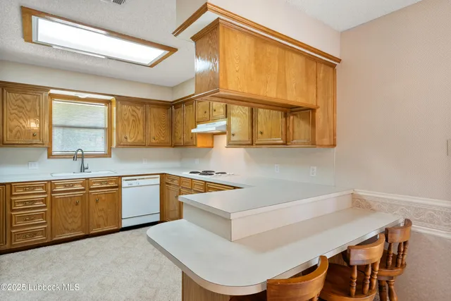a kitchen with a table chairs sink and window