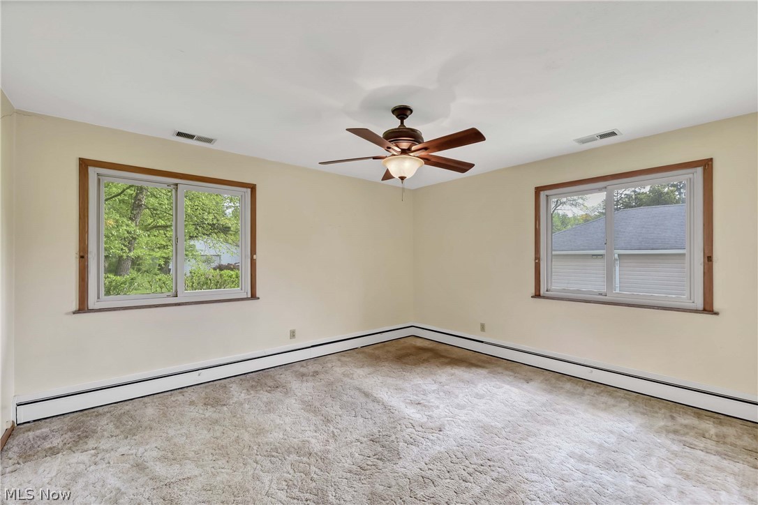 14593 Turney Road Maple Heights, OH 44137 - Photo 16 of 45 Carpeted bedroom with ceiling fan and baseboard heating