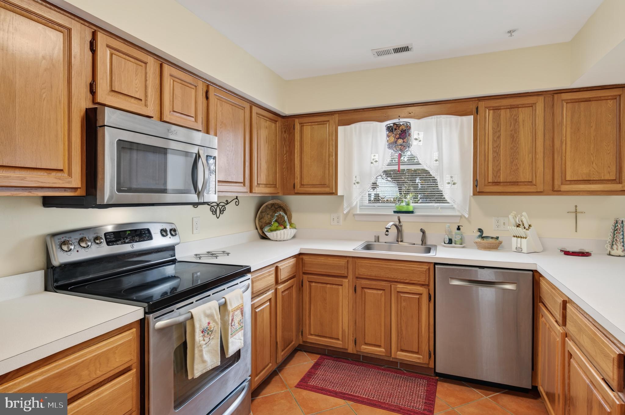 936 Bay Ridge Avenue, Unit 201 Annapolis, MD 21403 - Photo 21 of 40 a kitchen with stainless steel appliances a sink cabinets and a window