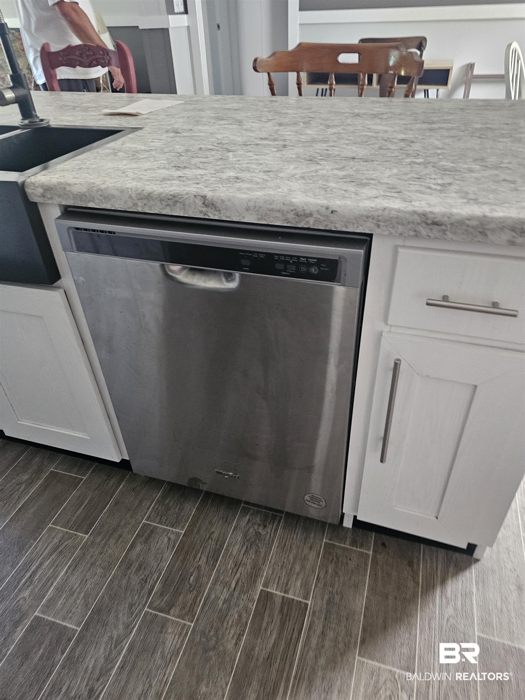 1863 Wait Road Monroeville, AL 36460 - Photo 24 of 38 Interior space featuring white cabinets, dark hardwood / wood-style flooring, and stainless steel dishwasher