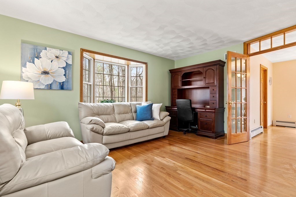 628 Boston Road Groton, MA 01450 - Photo 11 of 32 a living room with furniture windows and a flat screen tv