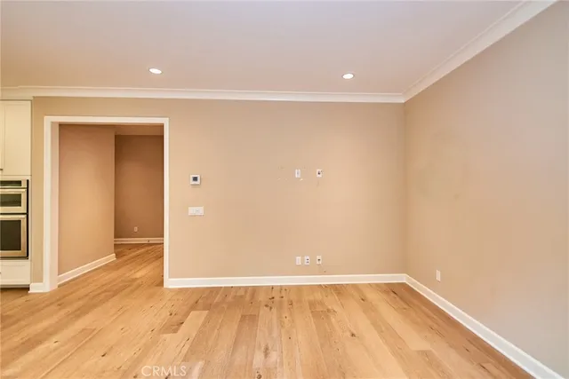 a large kitchen with a refrigerator and a stove top oven