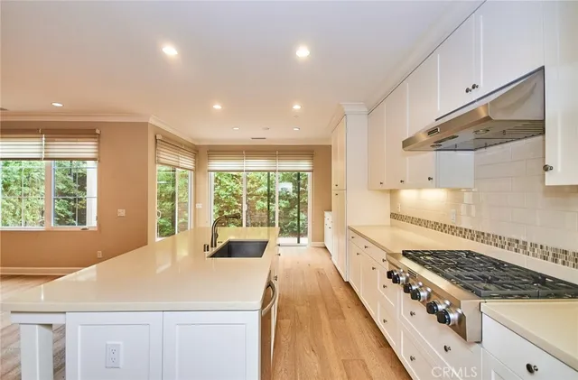 a kitchen with sink and large window
