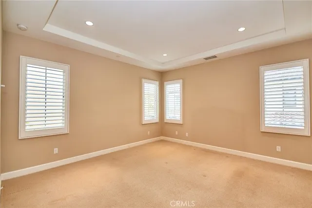 an empty room with windows and closet