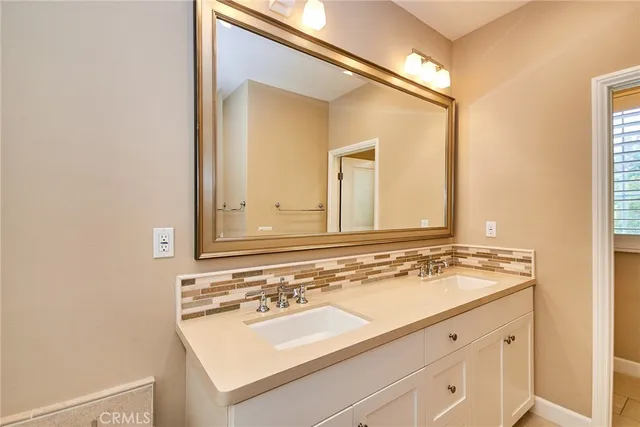 a view of an empty room with closet and a window