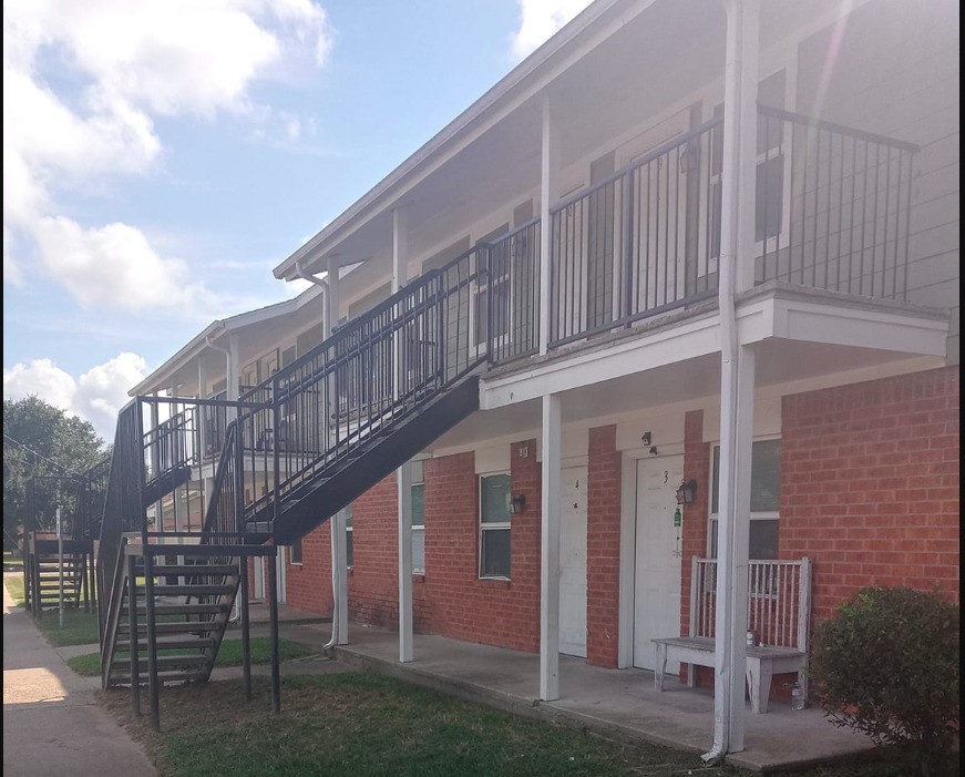 516 Laredo Street Navasota, TX 77868 - Photo 1 of 13 a large building with a view of a house