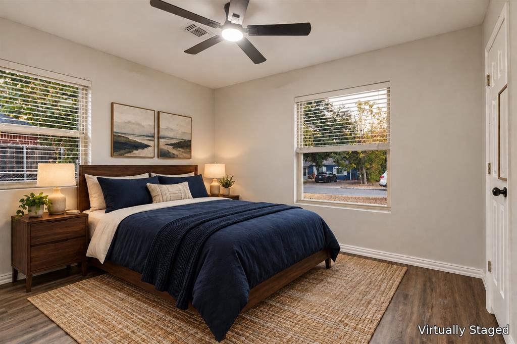 514 Chickapoo Trace Grand Prairie, TX 75051 - Photo 18 of 25 Neutral wall tones, wood-finish flooring, two windows with blinds, and a ceiling fan with integrated lighting
