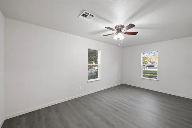 wooden floor in an empty room with a window