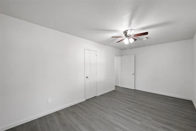 a view of an empty room with a fan