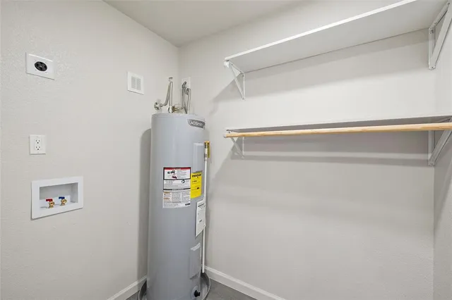 a view of storage and utility room with a refrigerator