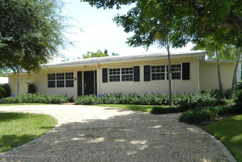 7312 Washington Road West Palm Beach, FL 33405 - Photo 2 of 10 a front view of a house with a yard and potted plants
