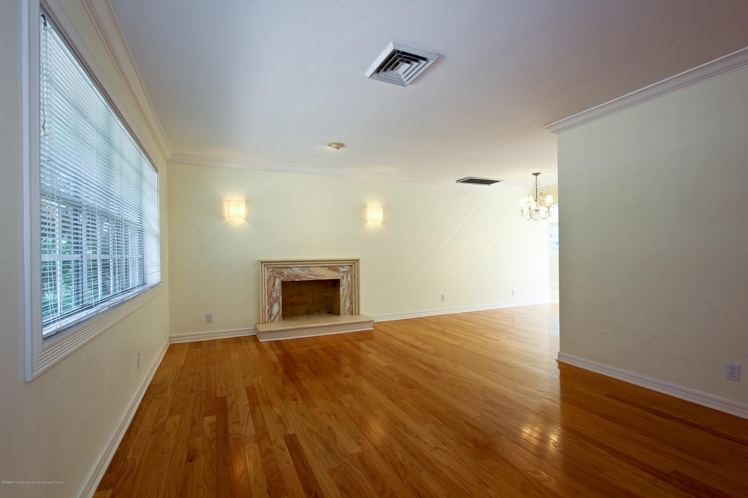 7312 Washington Road West Palm Beach, FL 33405 - Photo 3 of 10 a view of empty room with wooden floor and fireplace