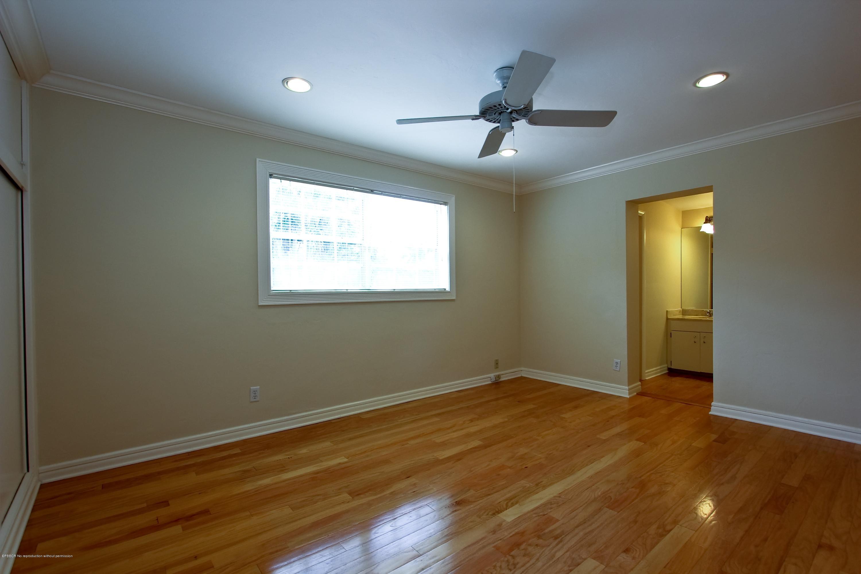 7312 Washington Road West Palm Beach, FL 33405 - Photo 7 of 10 a view of an empty room with wooden floor and a window