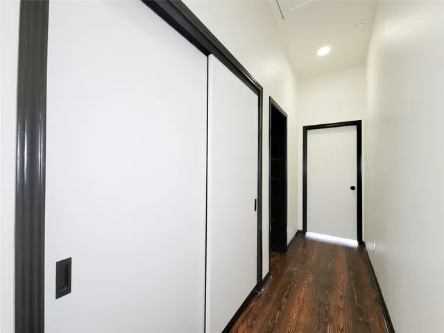 a view of hallway with wooden floor