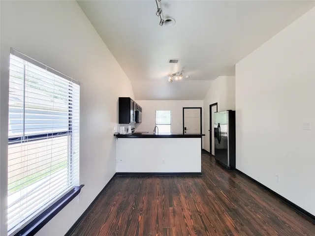 a view of kitchen with sink and window