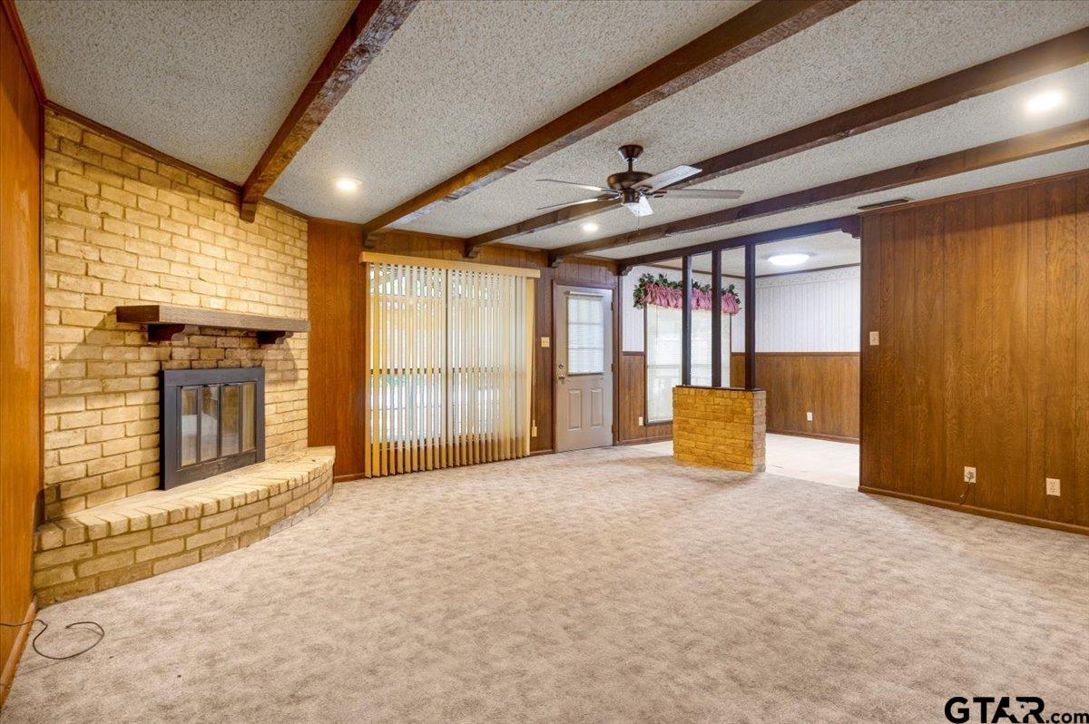 1302 Jeb Stuart Drive Tyler, TX 75703 - Photo 7 of 47 a view of an empty room with a fireplace and a window