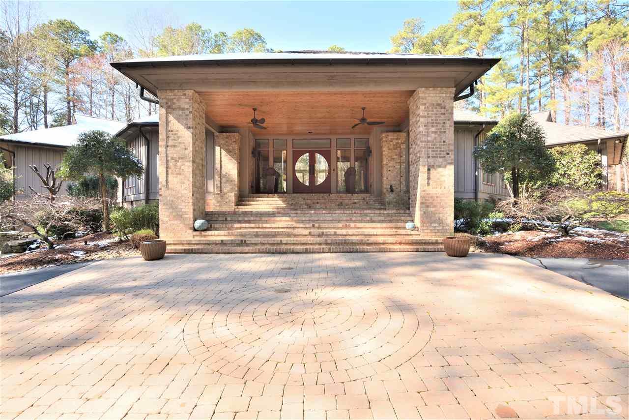 5217 Ginger Trail Raleigh, NC 27614 - Photo 27 of 30 Circular asphalt drive accented with pavers leads to the grand covered entrance overlooking serene water feature