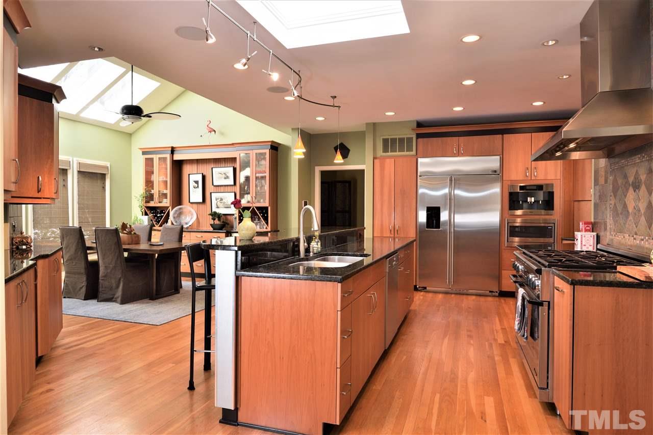 5217 Ginger Trail Raleigh, NC 27614 - Photo 9 of 30 Kitchen opens onto the sunlit dining area with four skylights and built-in cabinets with wine cooler