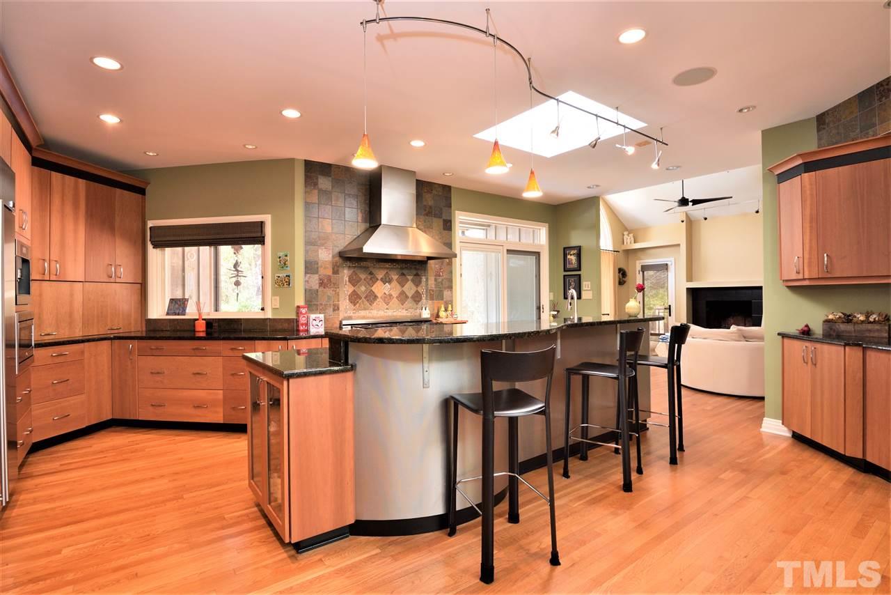 5217 Ginger Trail Raleigh, NC 27614 - Photo 10 of 30 6 burner Dacor gas stovetop above double ovens, new built-in microwave, GE Monogram refirgerator, Miele dishwasher, built-in Miele coffee maker and island for causal dining make this the hub of the home
