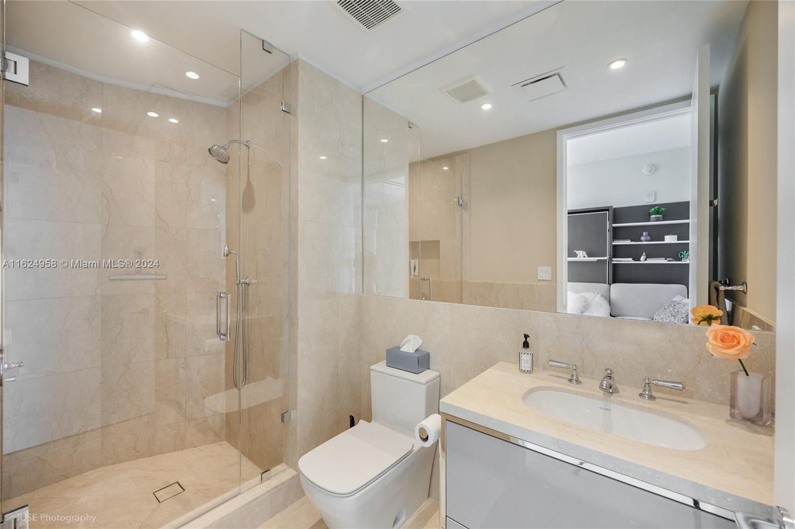 15701 Collins Avenue, Unit 4303 Sunny Isles Beach, FL 33160 - Photo 10 of 12 a bathroom with a sink a toilet and shower