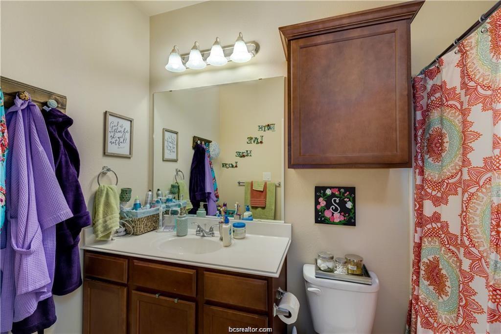 1198 Jones-Butler Road, Unit 406 College Station, TX 77840 - Photo 6 of 12 a bathroom with a sink vanity mirror and toilet