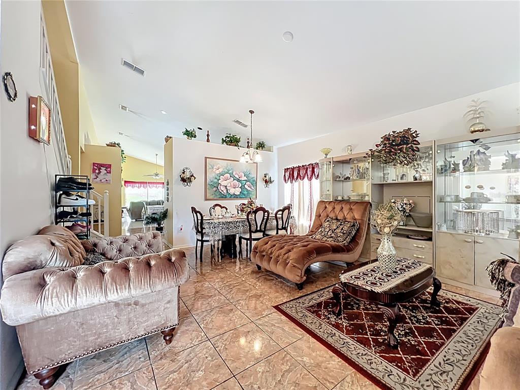 7939 Riffle Lane Orlando, FL 32818 - Photo 4 of 52 a living room with furniture and a rug