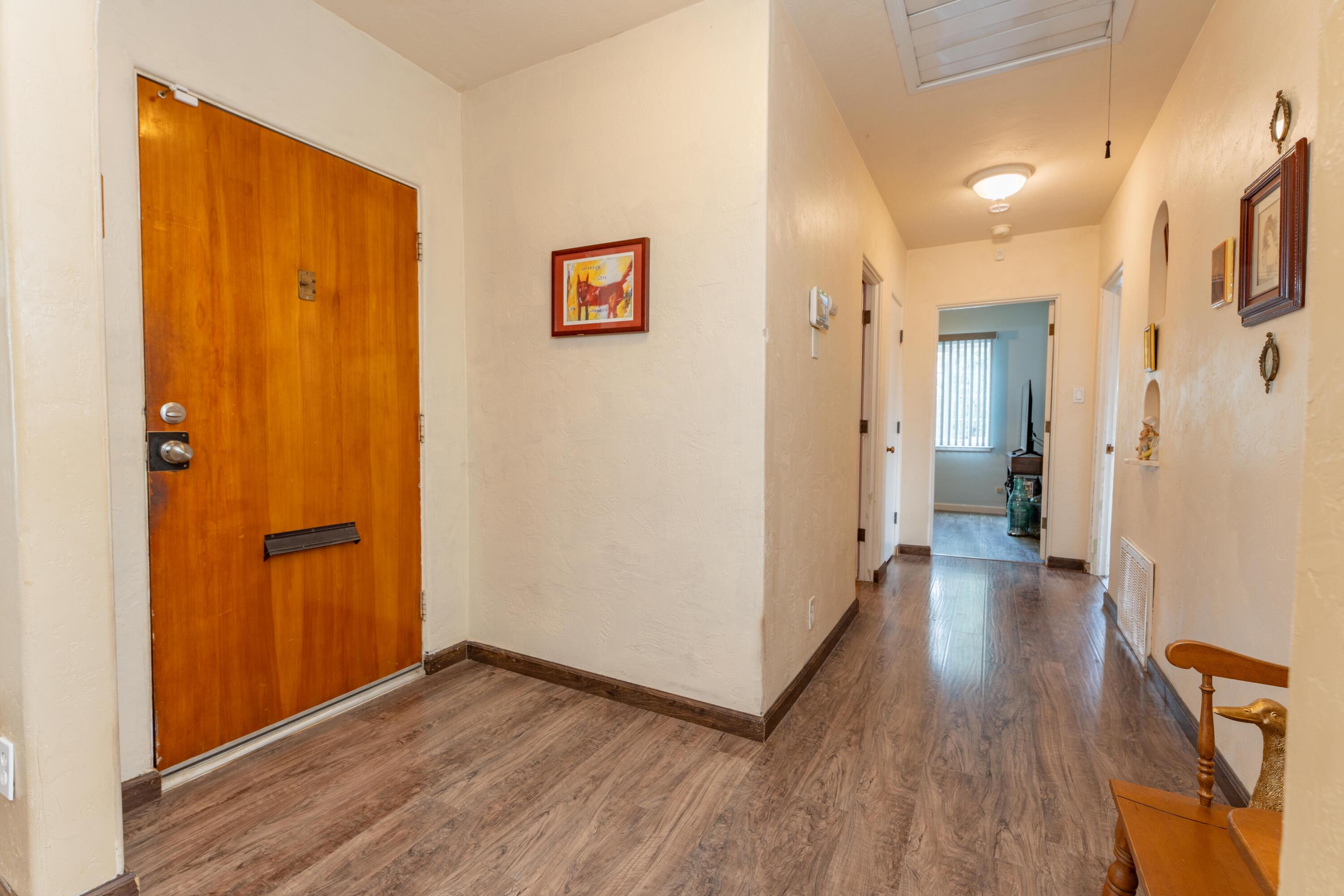 570 North Birch Avenue Reedley, CA 93654 - Photo 11 of 52 a view of a hallway with wooden floor and closet area