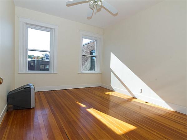 44 Orkney Road, Unit 5 Boston, MA 02135 - Photo 5 of 12 a view of empty room with wooden floor and fan