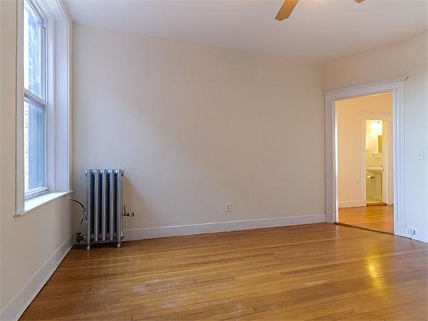 44 Orkney Road, Unit 5 Boston, MA 02135 - Photo 8 of 12 a view of an empty room with wooden floor and a window