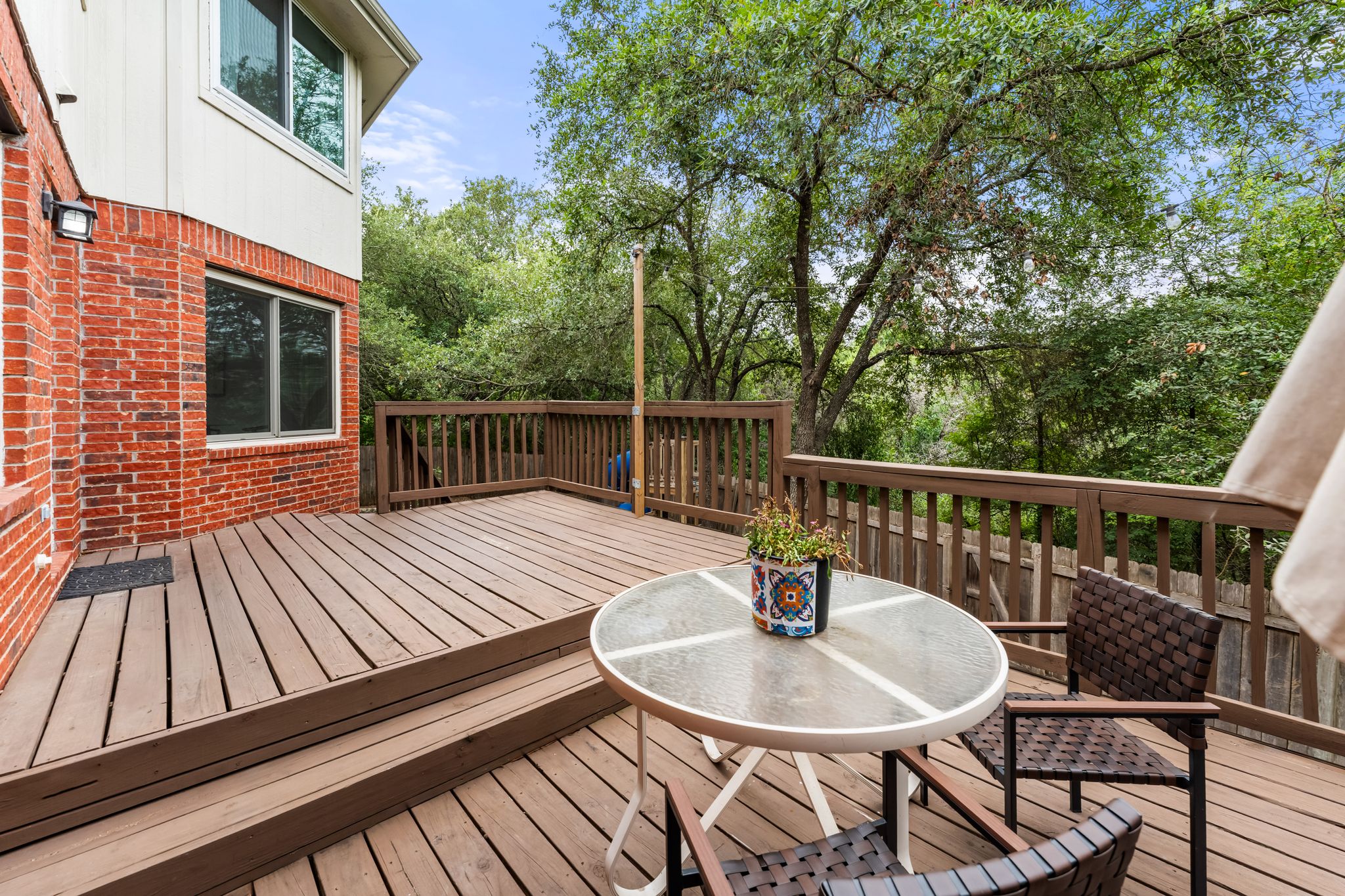3704 Caney Creek Road Austin, TX 78732 - Photo 32 of 40 A spacious wood deck extends from the home, offering ample outdoor living space with natural views.