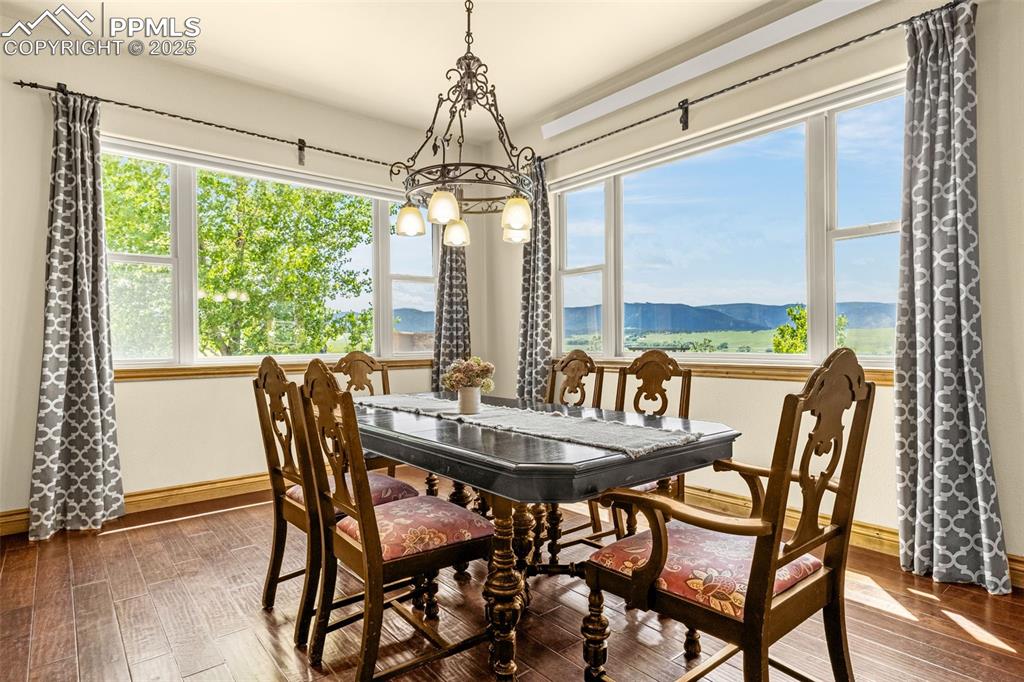 11784 Spruce Mountain Road Larkspur, CO 80118 - Photo 11 of 49 a view of a dining room with furniture window and wooden floor