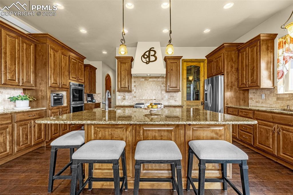 11784 Spruce Mountain Road Larkspur, CO 80118 - Photo 13 of 49 a large kitchen with a table and chairs