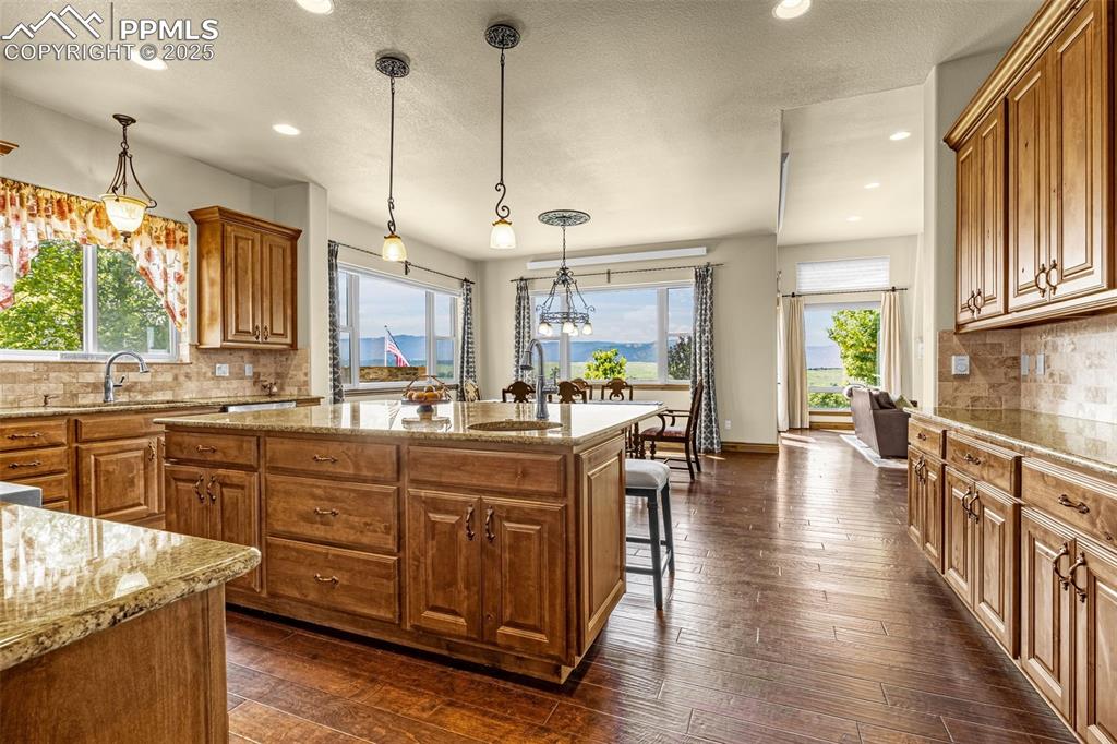 11784 Spruce Mountain Road Larkspur, CO 80118 - Photo 14 of 49 a kitchen with lots of counter top space and dining table