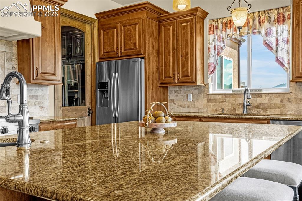 11784 Spruce Mountain Road Larkspur, CO 80118 - Photo 17 of 49 a kitchen with refrigerator and window