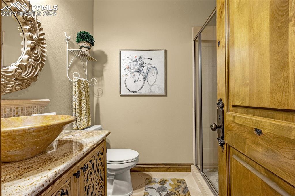 11784 Spruce Mountain Road Larkspur, CO 80118 - Photo 18 of 49 a bathroom with a granite countertop toilet and a sink