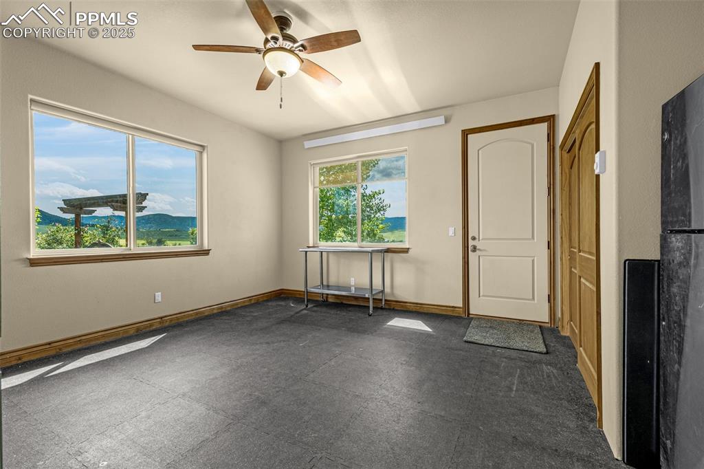 11784 Spruce Mountain Road Larkspur, CO 80118 - Photo 20 of 49 an empty room with windows and closet