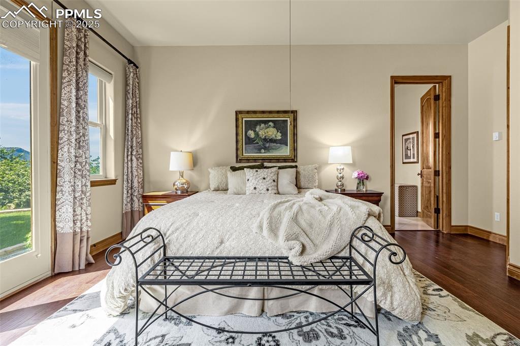 11784 Spruce Mountain Road Larkspur, CO 80118 - Photo 21 of 49 a bed sitting in a bedroom next to a window