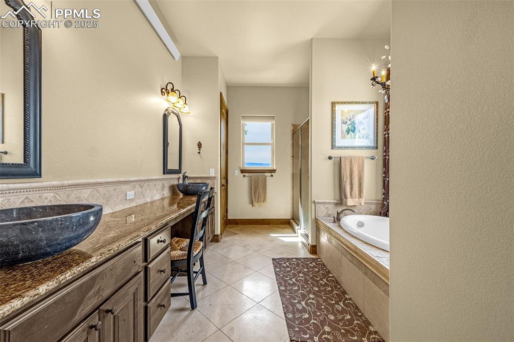 11784 Spruce Mountain Road Larkspur, CO 80118 - Photo 23 of 49 a bathroom with a granite countertop sink and a mirror