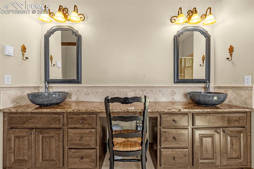 11784 Spruce Mountain Road Larkspur, CO 80118 - Photo 24 of 49 a bathroom with a sink and a mirror