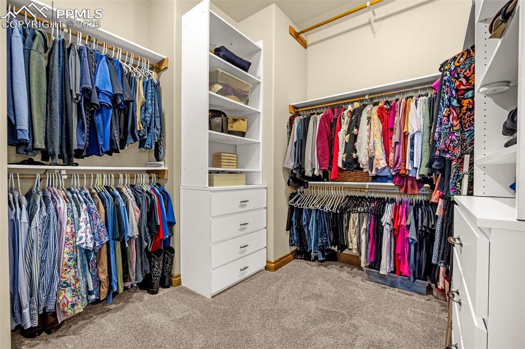 11784 Spruce Mountain Road Larkspur, CO 80118 - Photo 33 of 49 a view of walk in closet with clothes
