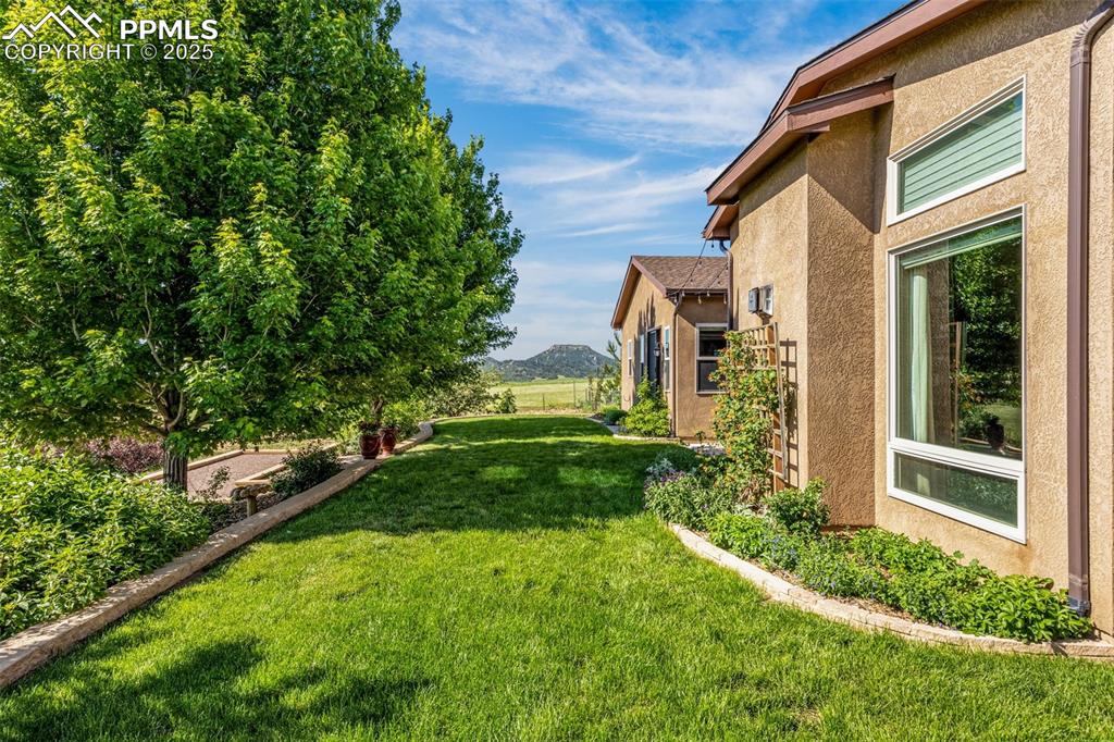 11784 Spruce Mountain Road Larkspur, CO 80118 - Photo 34 of 49 a view of an house with backyard space and garden