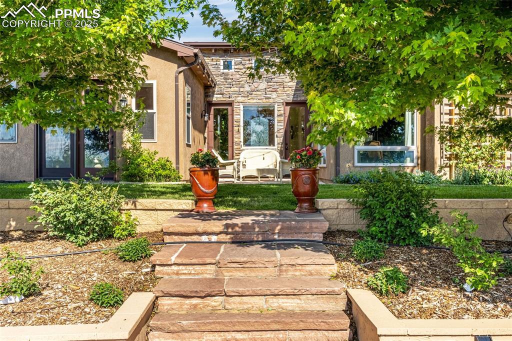 11784 Spruce Mountain Road Larkspur, CO 80118 - Photo 36 of 49 a front view of a house with garden